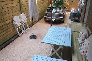 Making the best of what you have to work with. An unused space is transformed into a driveway and patio area.