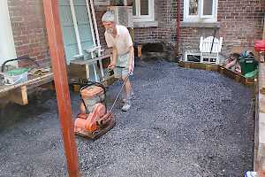 Once forms were put in place the surface was filled and tamped down in preparation for the CORE grid foundation.